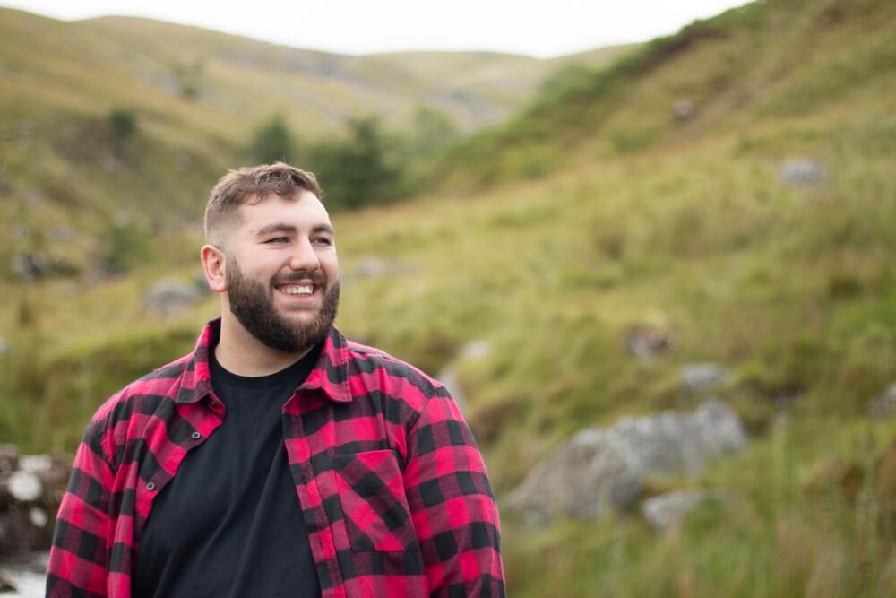 Man in checked shirt in field