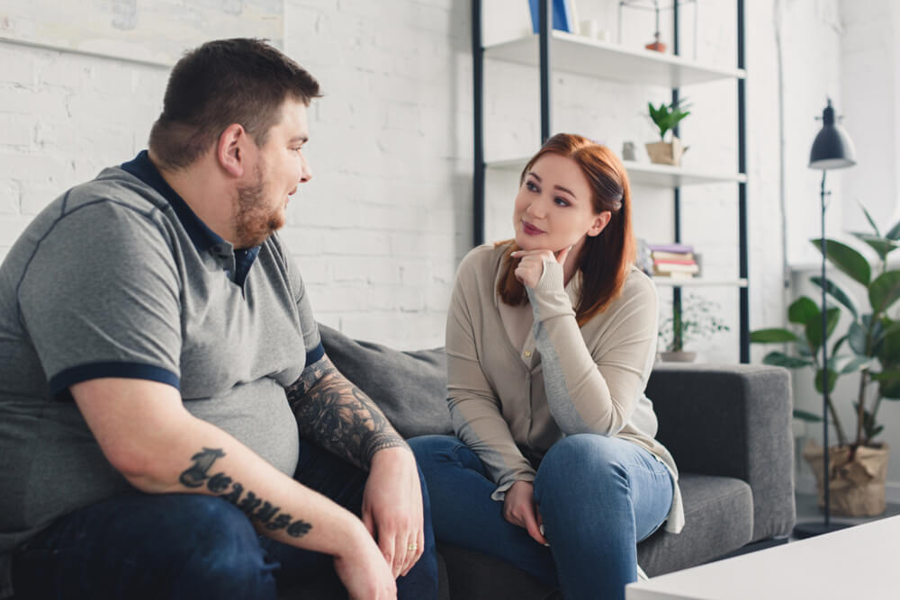 Boyfriend,And,Girlfriend,Looking,At,Each,Other,On,Sofa,At